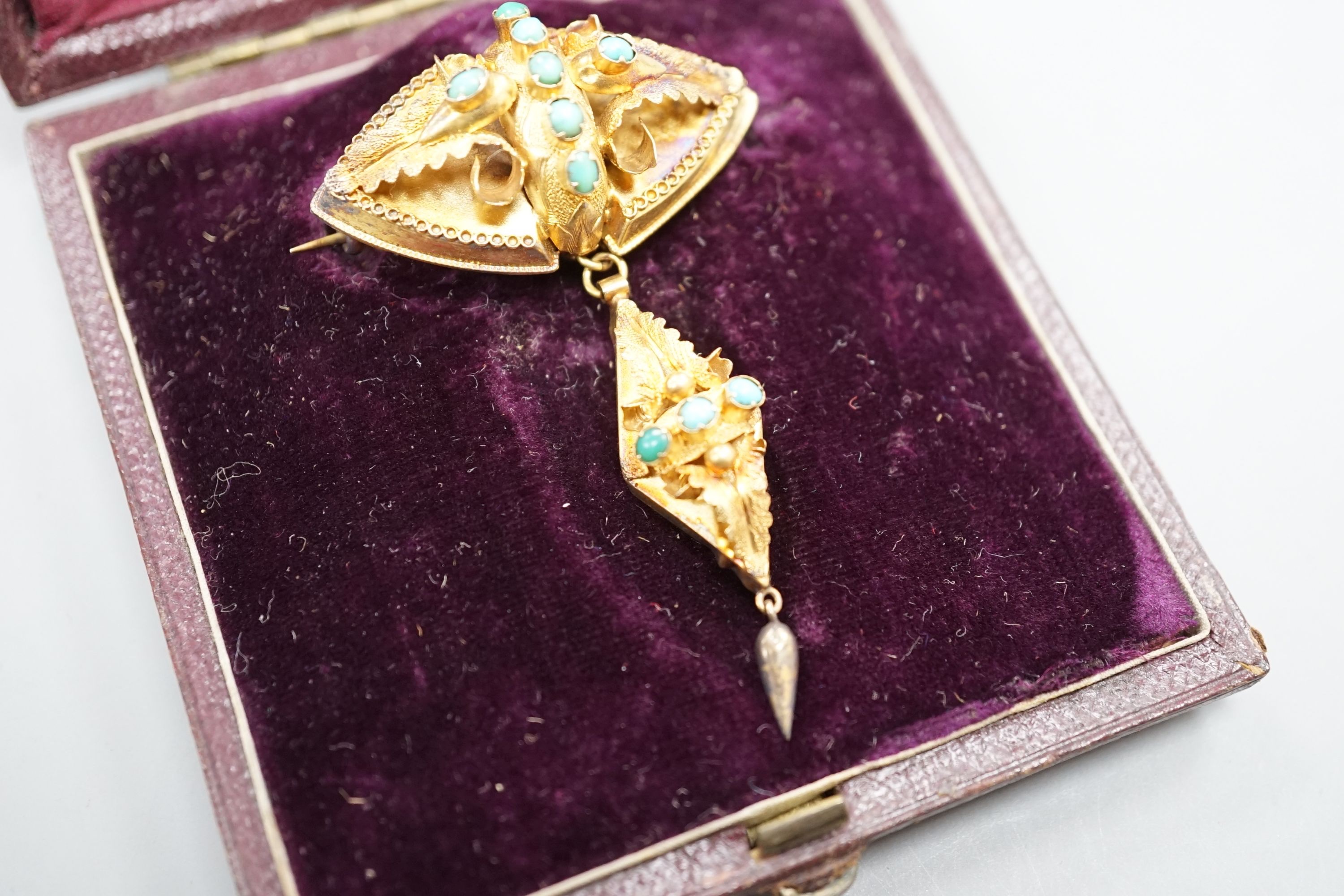 A Victorian yellow metal and cabochon turquoise set drop brooch, in fitted leather box, 55mm, gross 4.9 grams.